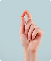 A hand holding between finger a MigreLief+M supplement