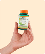 A hand holding out a bottle of MigreLief+M