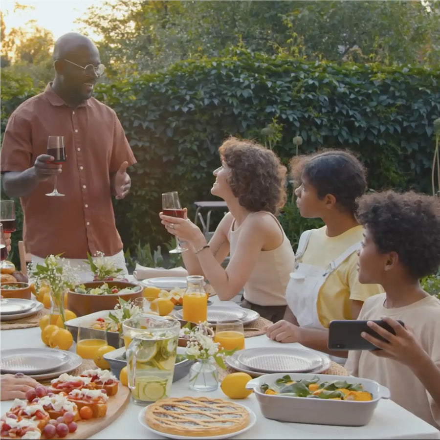 People gathering outside and enjoying a meal.