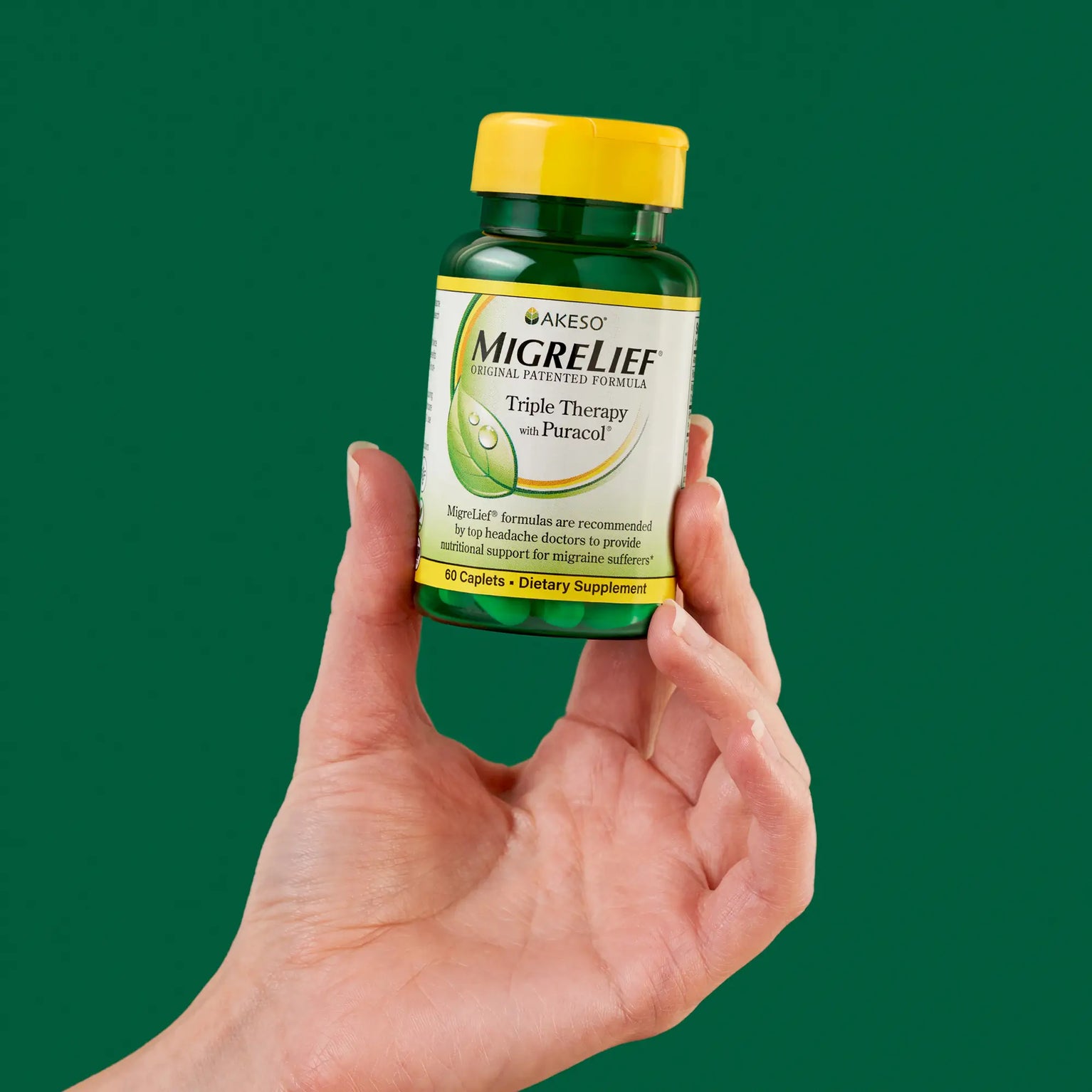 MigreLief Triple Therapy bottle held in hand